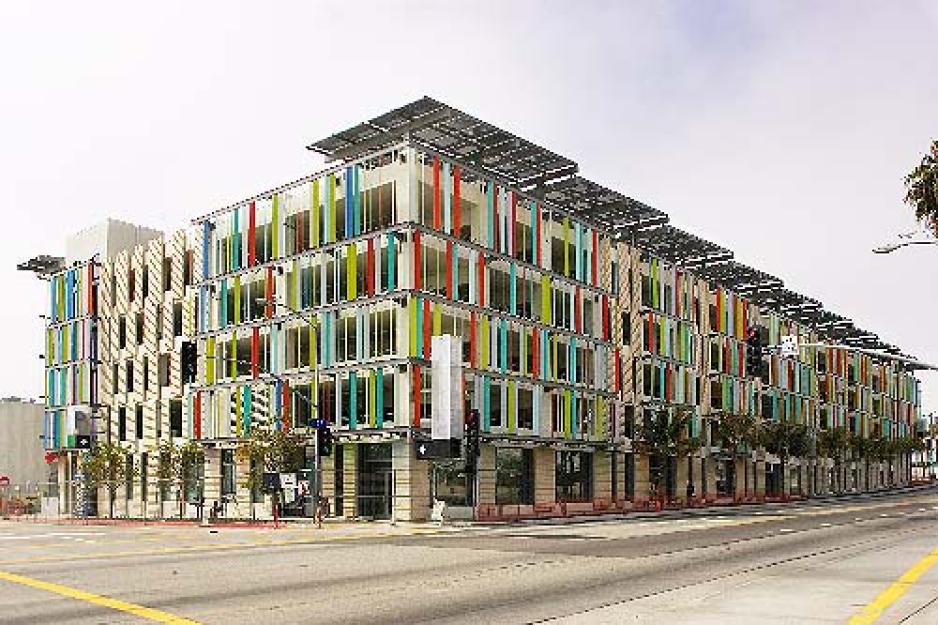 A graphic of a colorful parking garage with solar panels on top. 