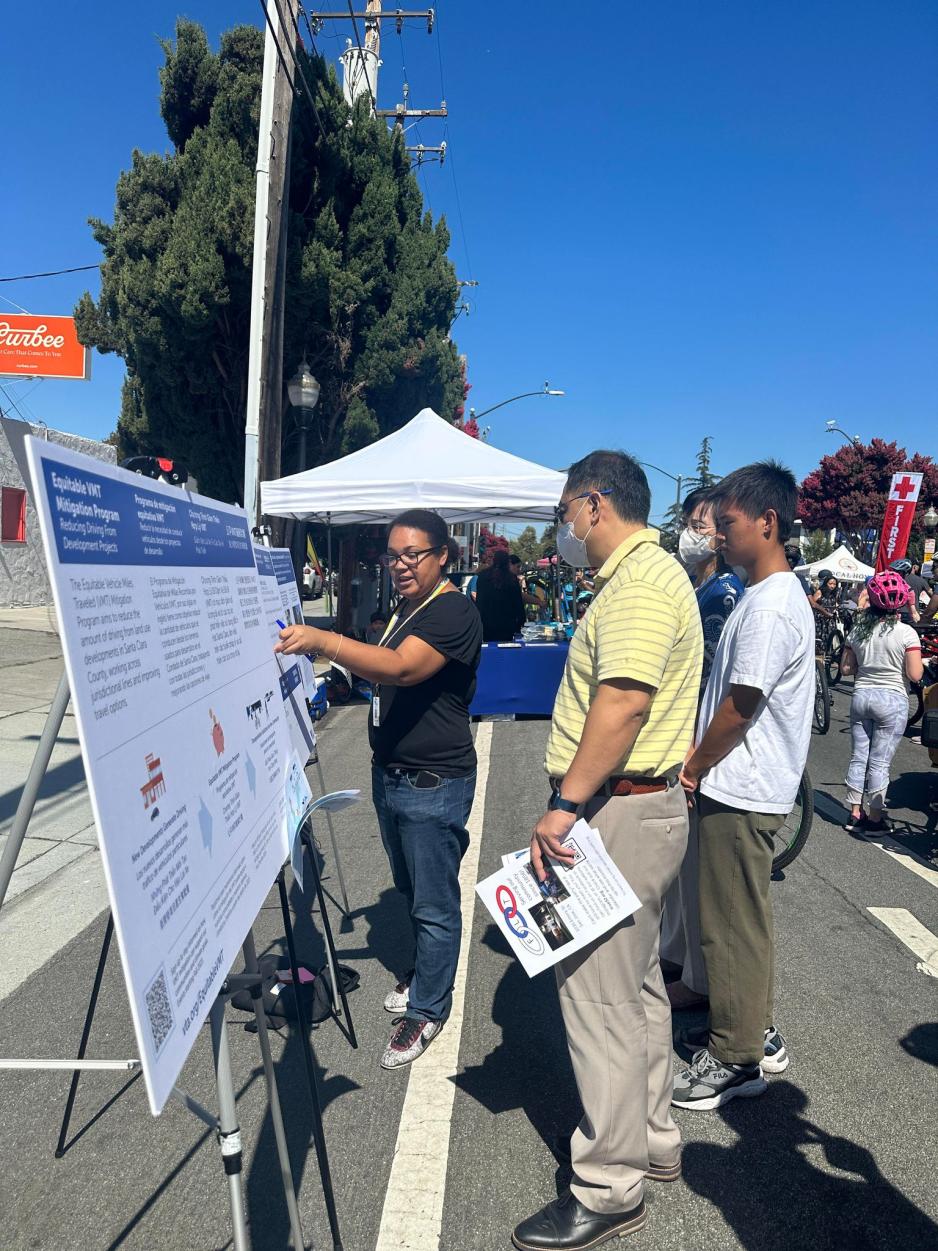 people looking at map and display board